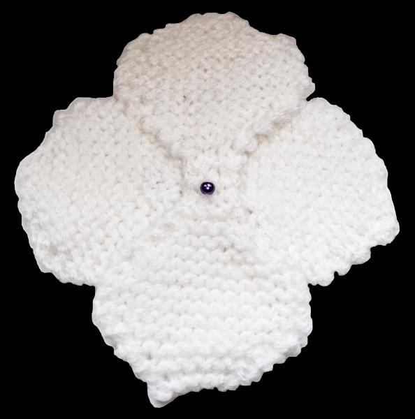 Hand knitted brooch in white with purple pearl